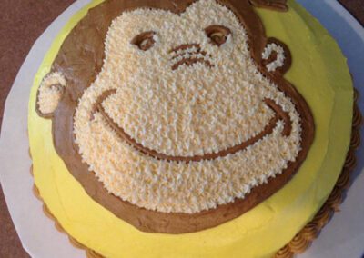 A unique cake shaped like a monkey's face. The cake features intricate detailing to resemble a monkey's facial features