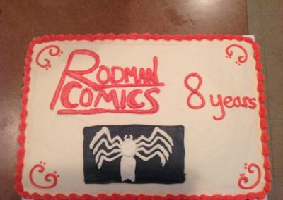 A gluten-free cake for an 8-year-old child, featuring a Rodman comics theme. The cake is suitable for those with gluten sensitivities and is decorated with designs inspired by Rodman comics, creating a fun and enjoyable dessert for the celebration